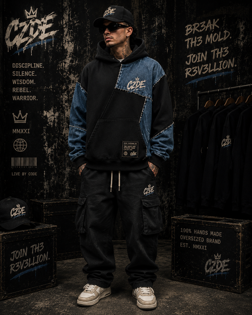 Male model wearing CZDE Denim Patchwork Hoodie – front view, dark editorial background with CZDE branding