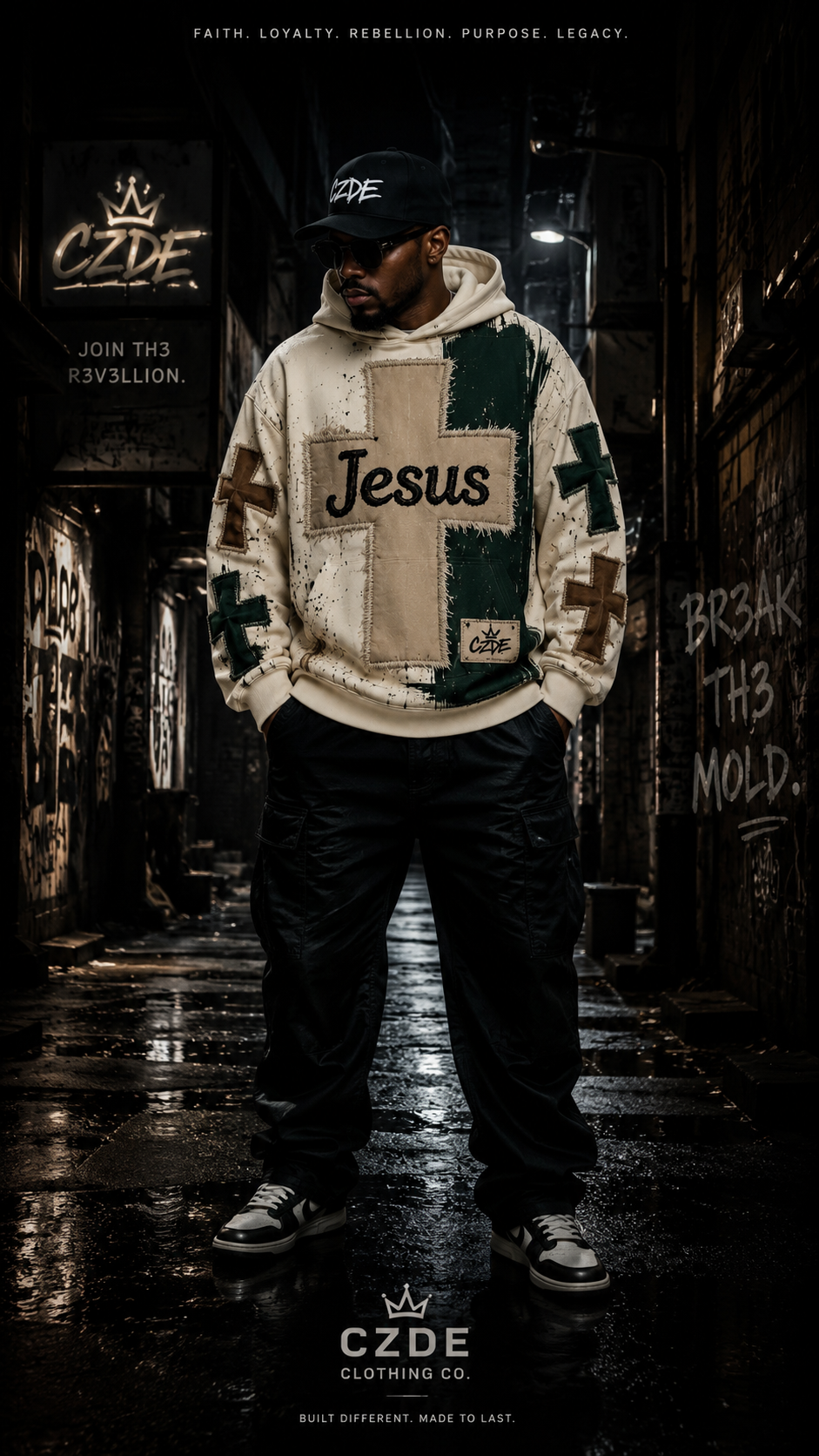Male model wearing CZDE Jesus Cross Hoodie – front view, dark alley street editorial with CZDE graffiti wall