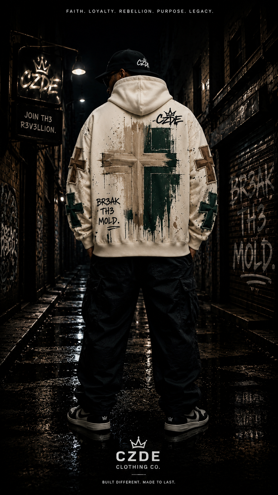 Male model wearing CZDE Jesus Cross Hoodie – back view showing BR3AK TH3 MOLD brushstroke cross print, dark alley editorial
