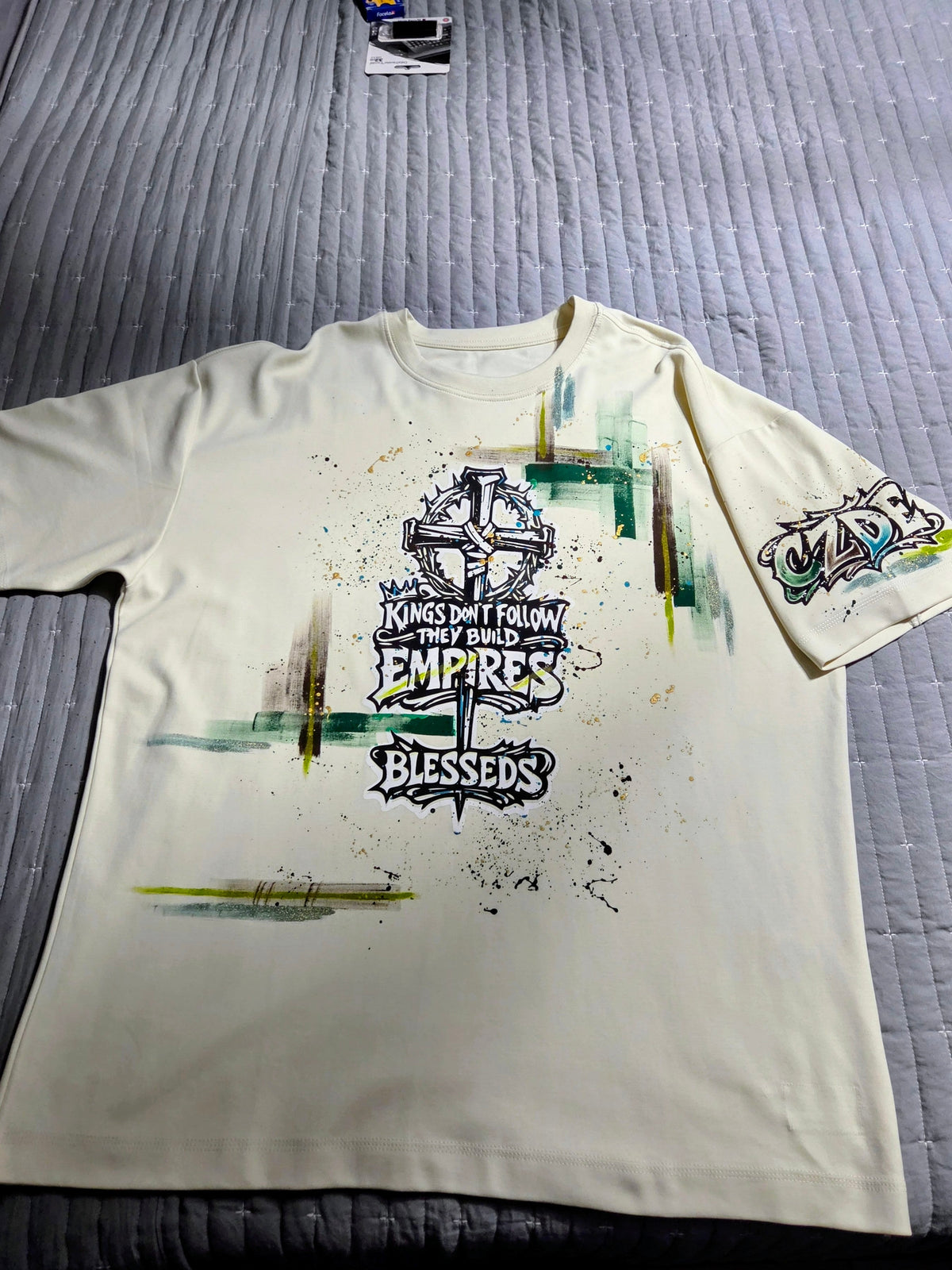 CZDE Build Empires Graffiti Tee – Full front view with cross graphic and paint splatter