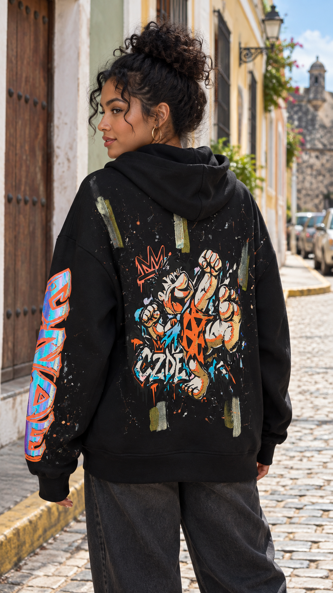 Black oversized hoodie with colorful graffiti back art and graffiti sleeve detail