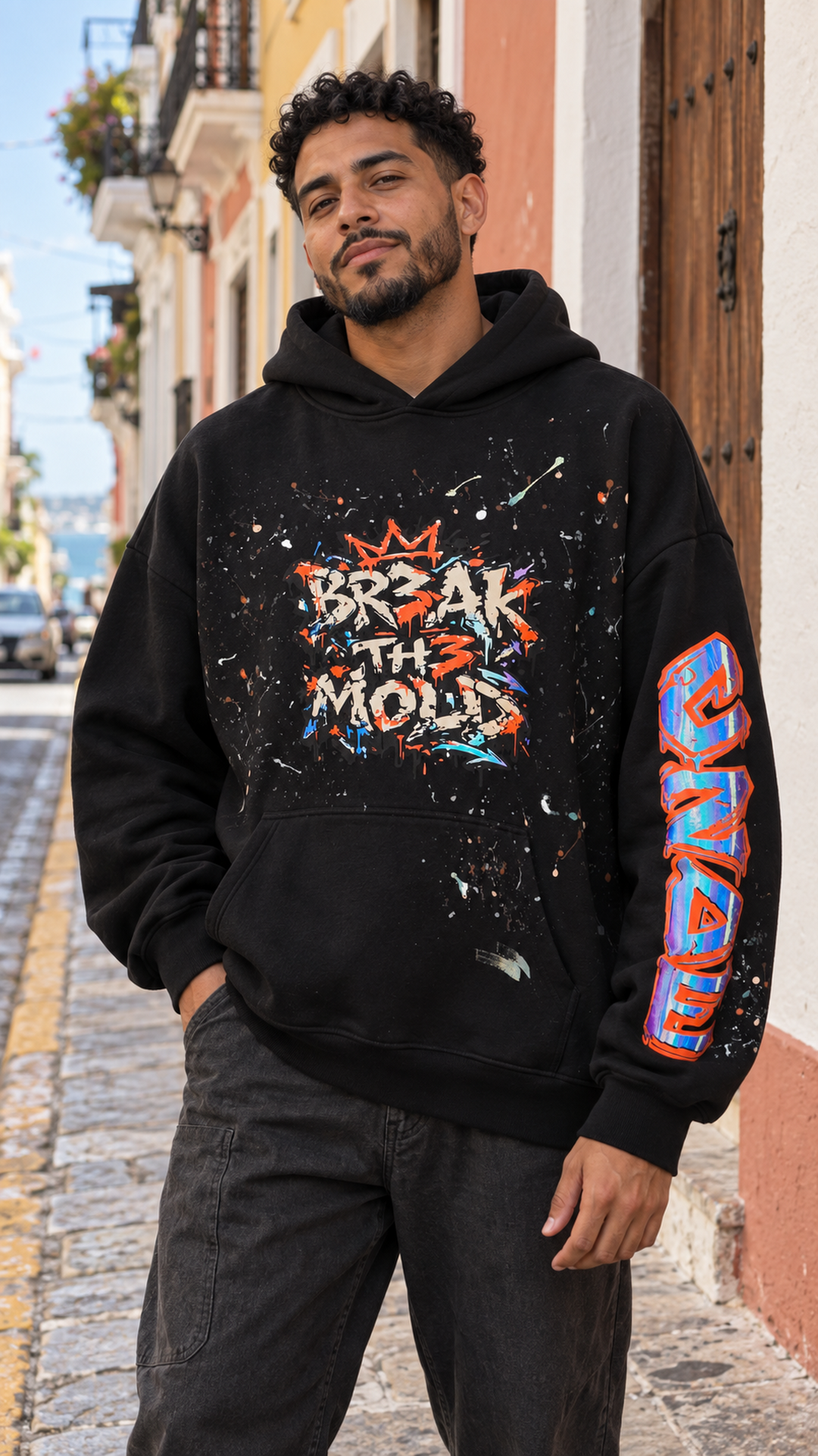 Black oversized hoodie with colorful graffiti chest print and graffiti sleeve graphic
