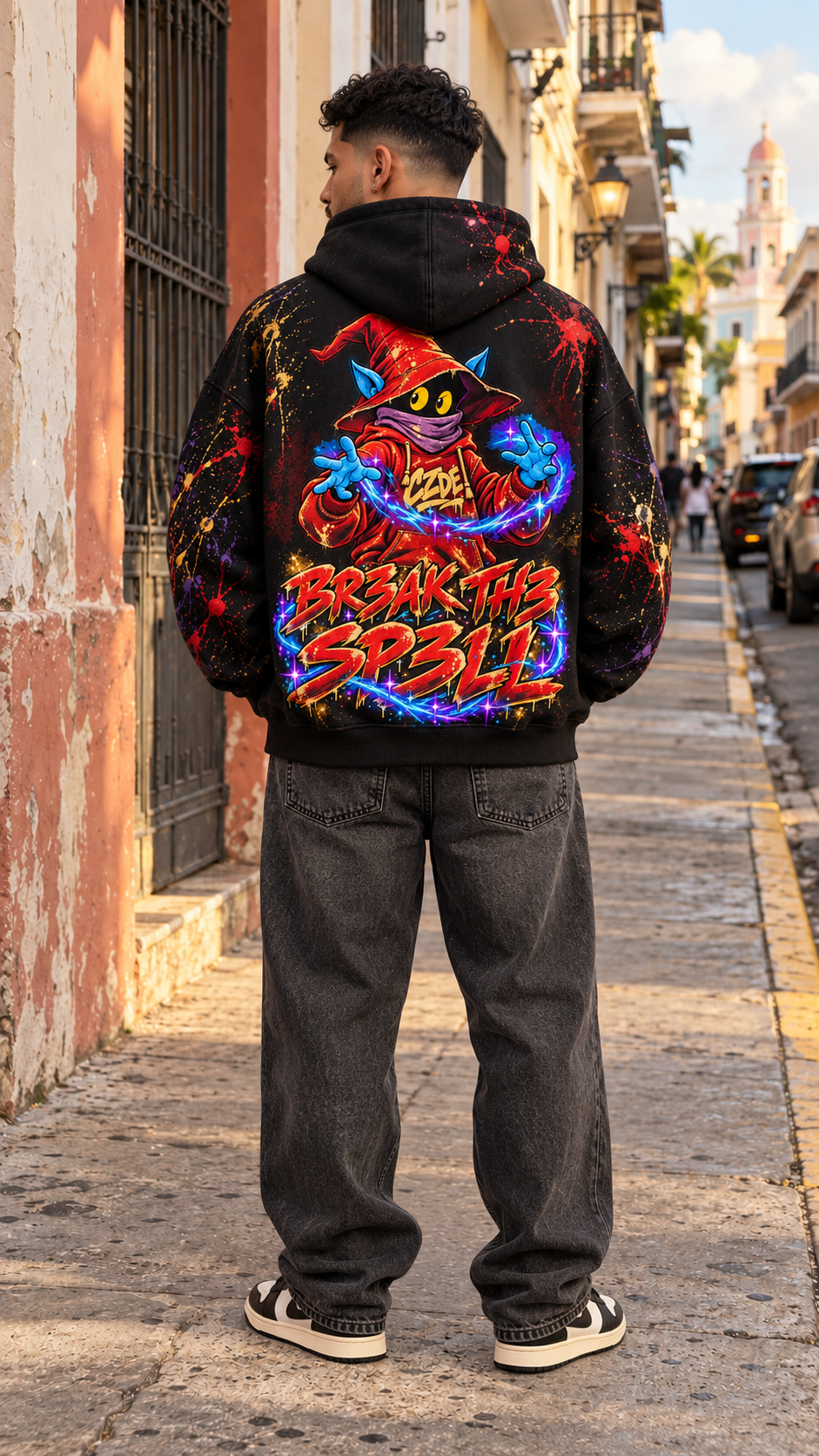 Black oversized hoodie showing large wizard “Break the Spell” graphic on back