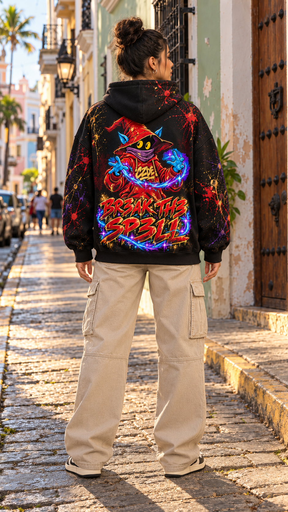 Black hoodie with large colorful wizard “Break the Spell” graphic on back
